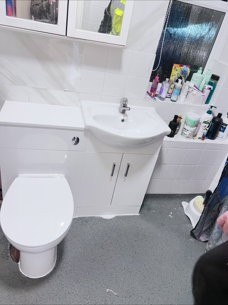New basin vanity unit and toilet fitted in a family bathroom