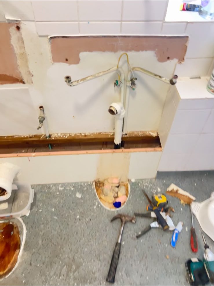Bathroom strip-out ready for new pipework and suite